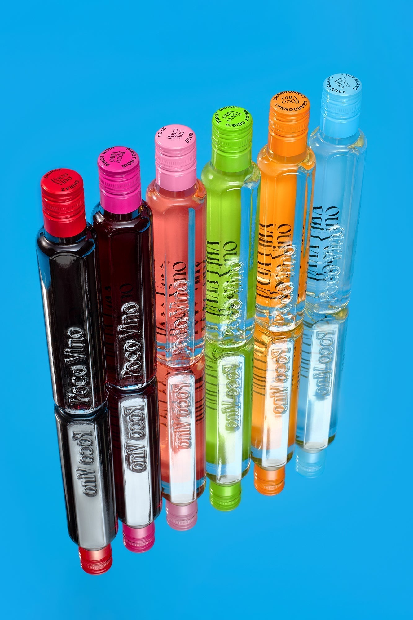 Poco Vino UK Wine Range stacked on mirror and blue background